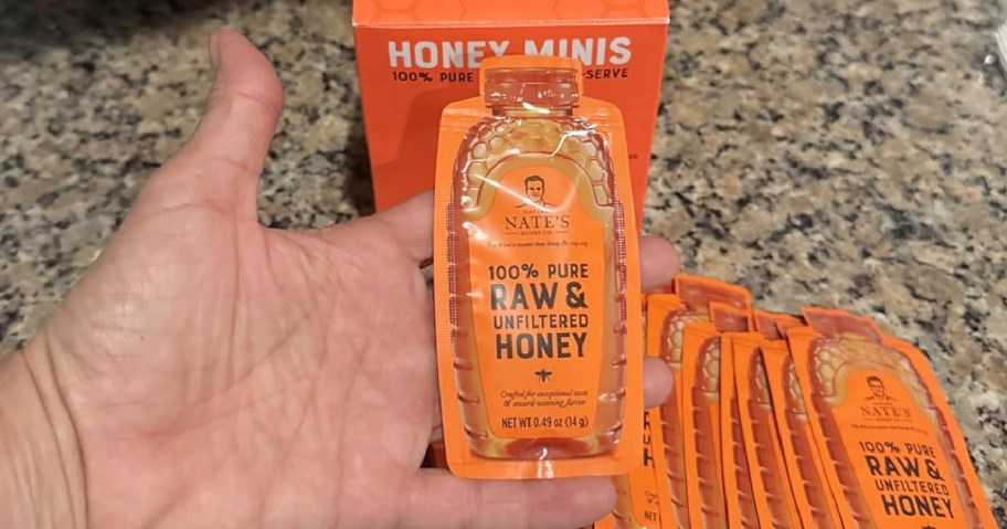 Hand holding Nate's Honey Minis 