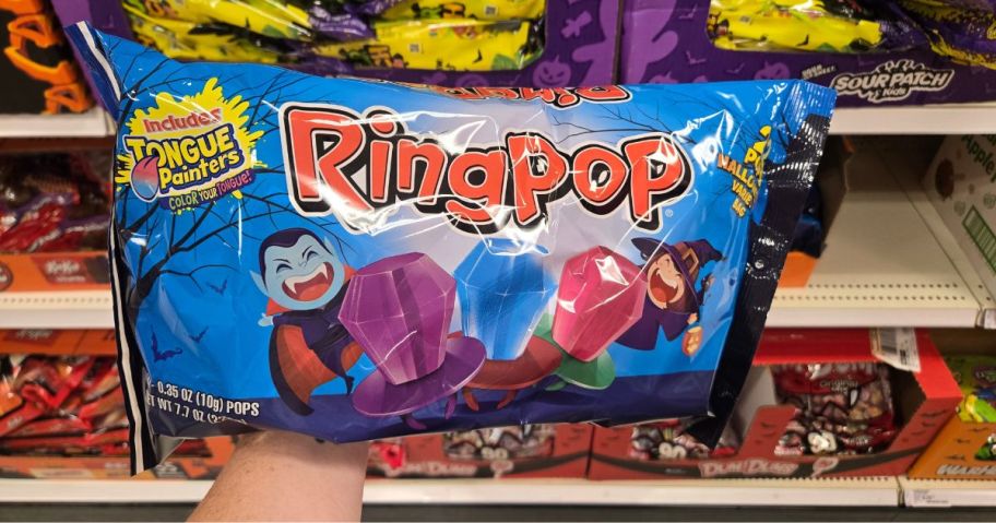 A person holding a bag of Ringpops in a store