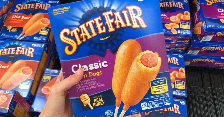 Hand holding a box of State Fair corn dogs