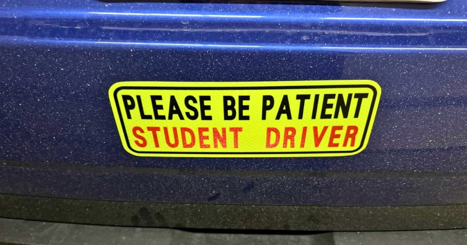 bumper of a car with a "Please be Patient, Student Driver" magnet on it