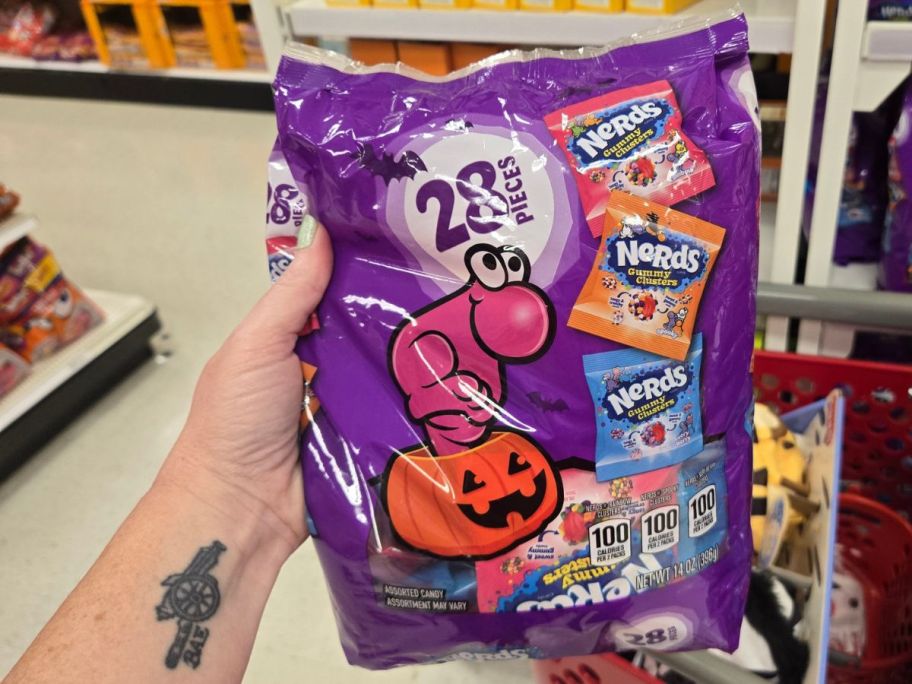 A person holding a bag of Nerds in a store