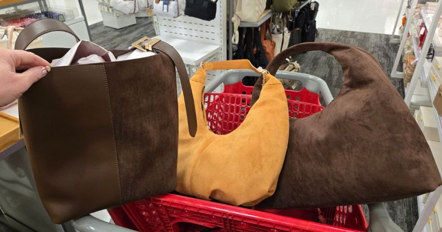 A target shopping cart with 3 fall handbags in the front basket