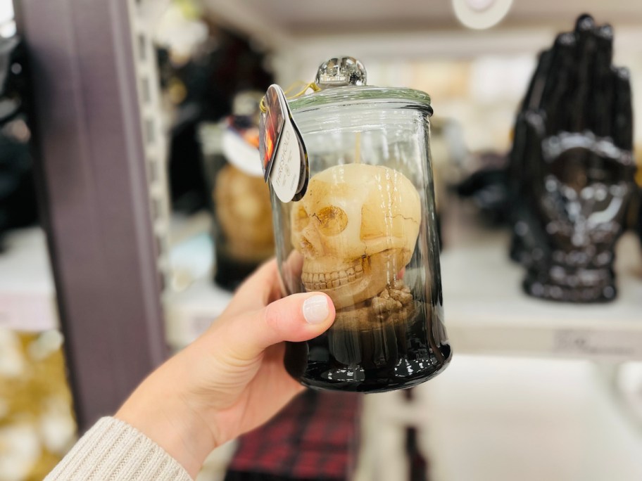hand holding skeleton jar candle