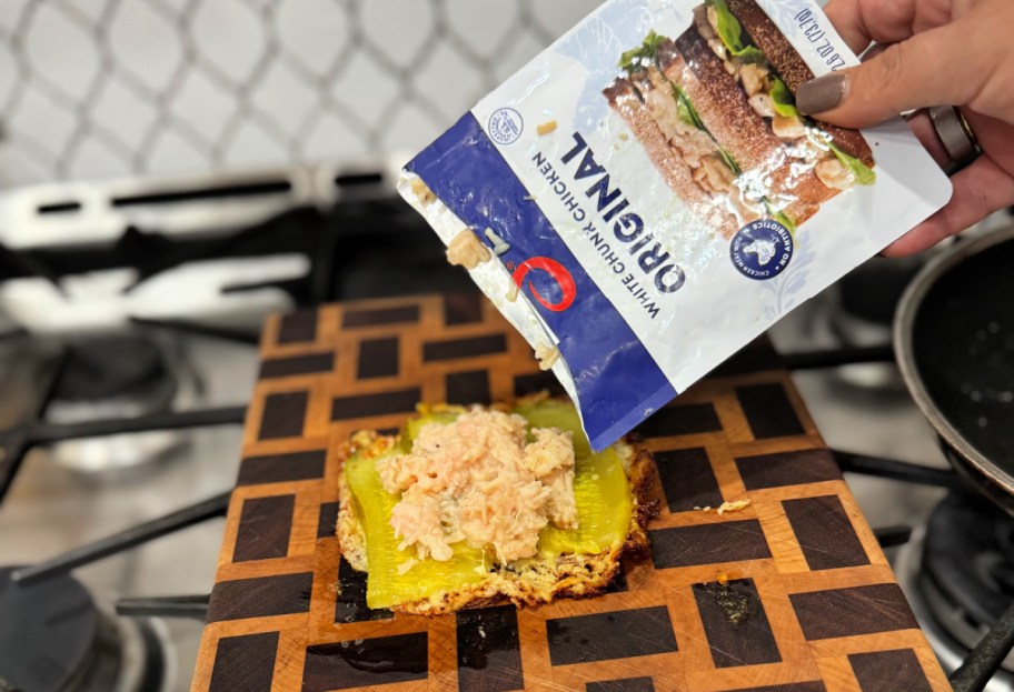 adding chicken from a packet to the sandwich