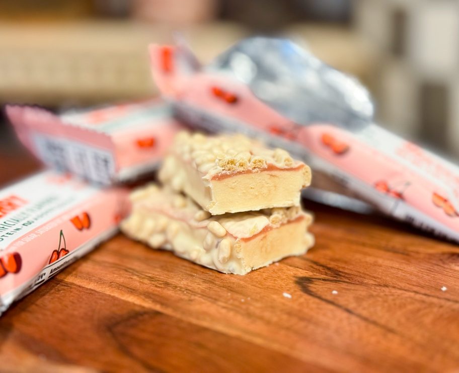 barebells protein bar cut in half next to wrappers