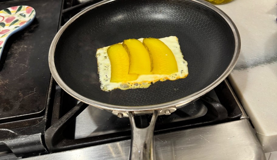 frying pan with cheese and pickles
