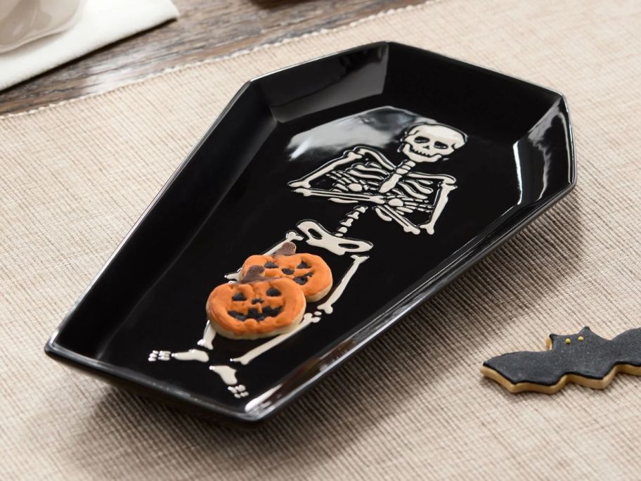 black Coffin-Shaped Serving Tray on table with cookies on it