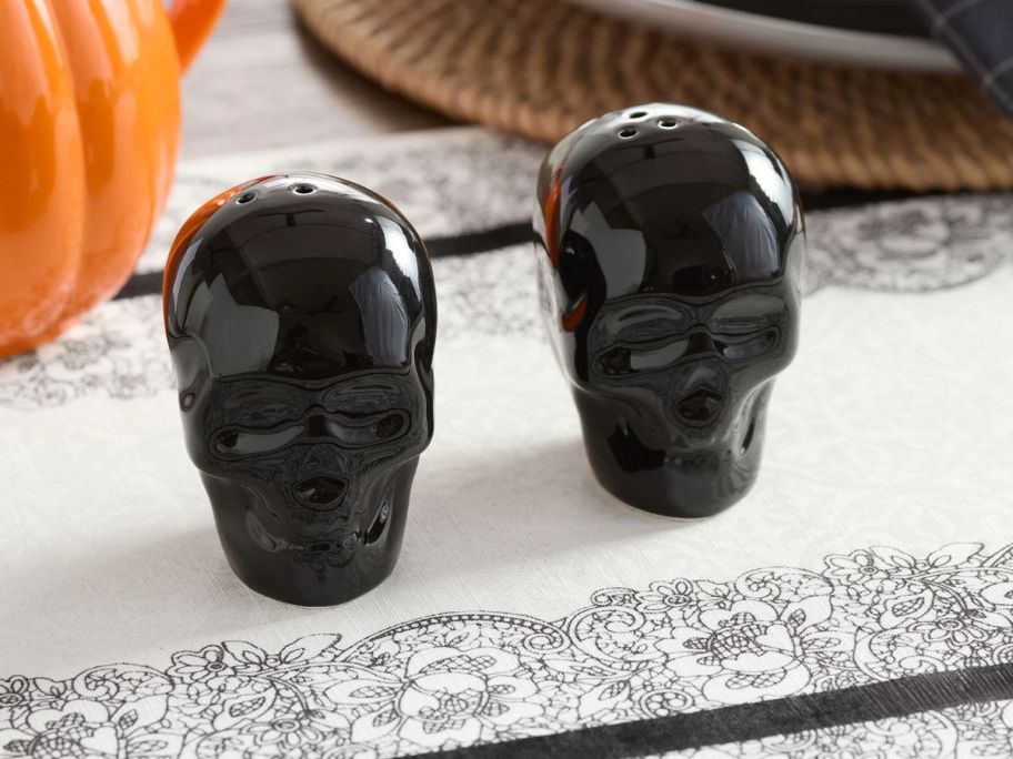 Black Skull-Shaped Ceramic Salt & Pepper Shaker Set on table