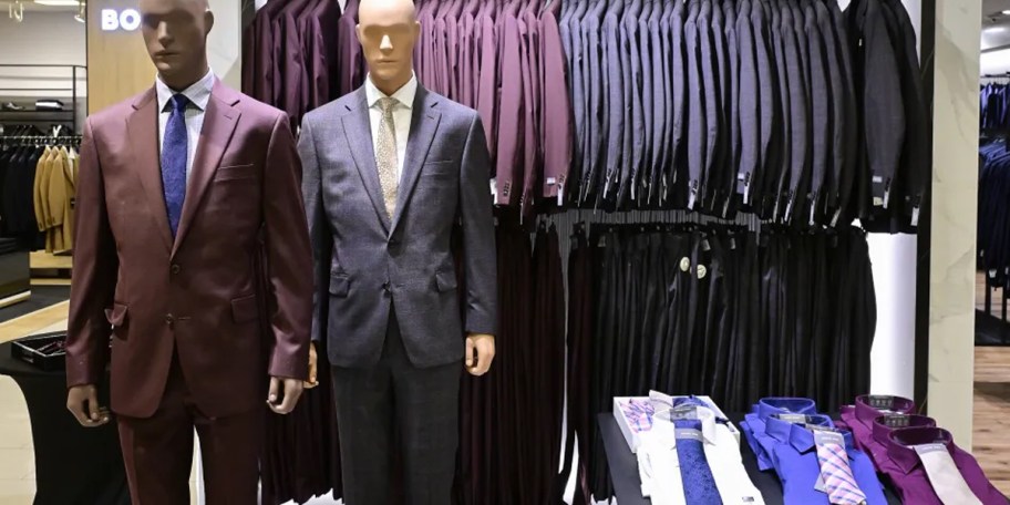 mannequins and suits hanging in store