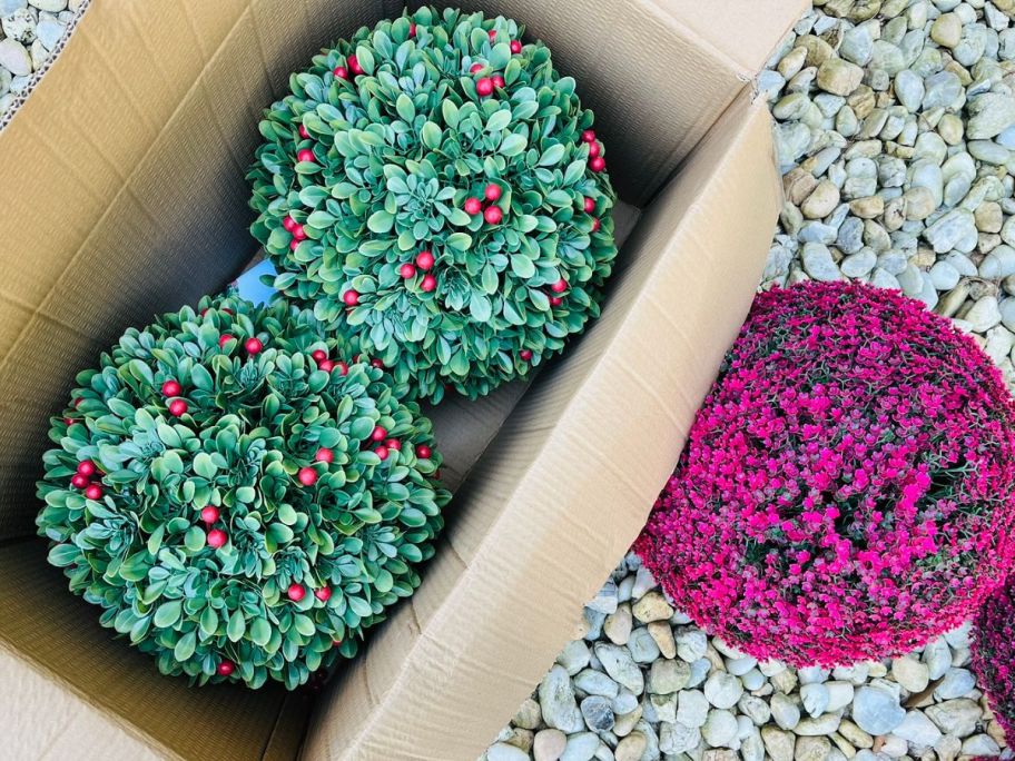 three different spheres displayed inside of the box and outside 