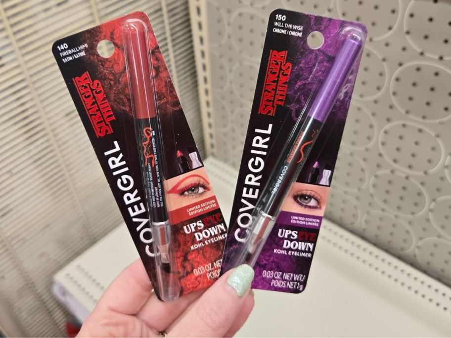 red and purple COVERGIRL x STRANGER THINGS UpsEYE Down Kohl Eyeliners in hand in store