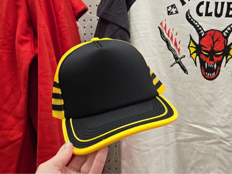 Stranger Things Dustin Henderson Black & Yellow Cosplay Trucker Hat in hand in store
