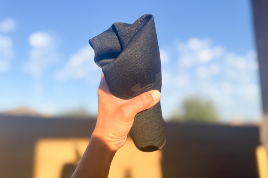 hand crumpling black hat
