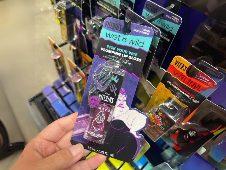 Wet N Wild Disney Villains Pick Your Vice Plumping Lip Gloss in hand in store