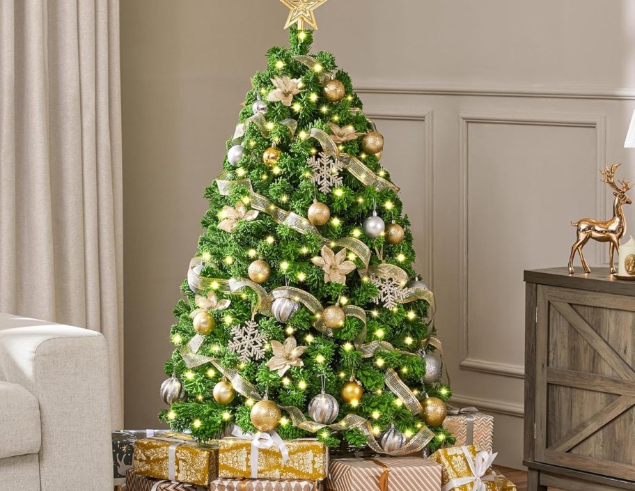 green christmas tree with lights and white decorations 