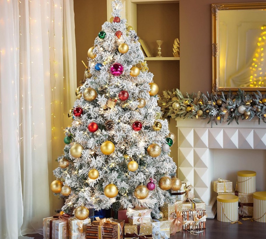 white flocked christmas tree with gold and red decorations 