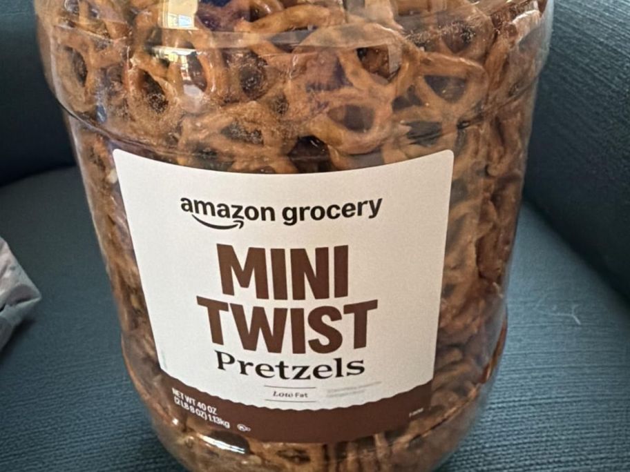 A large canister of Amazon Grocery Mini Pretzels