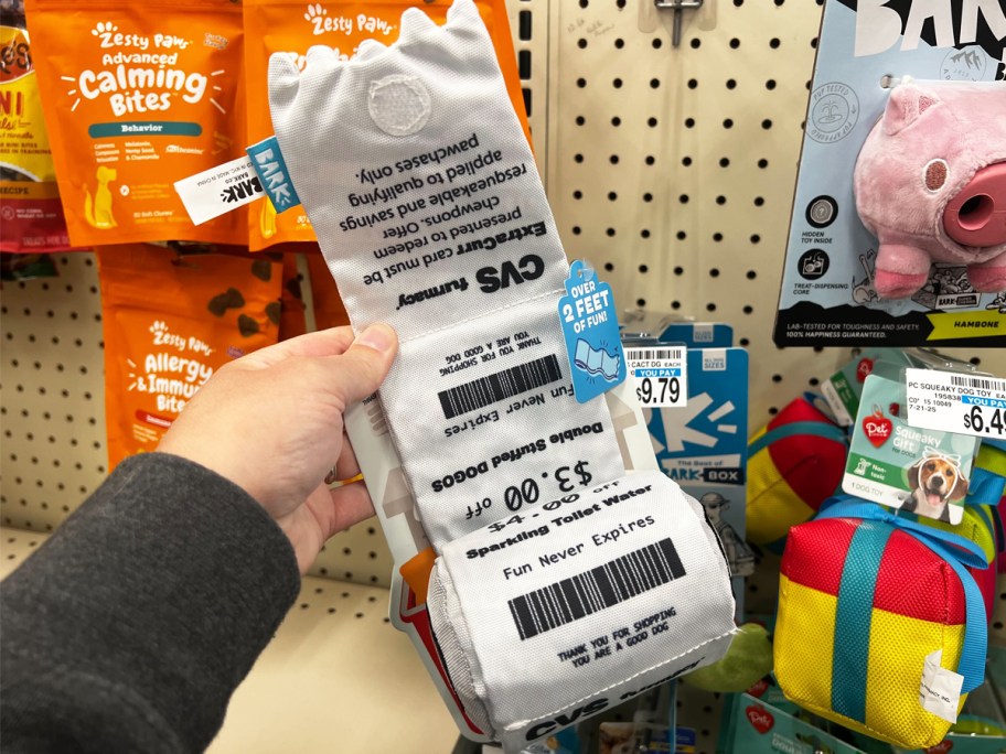 hand holding a dog receipt toy in store