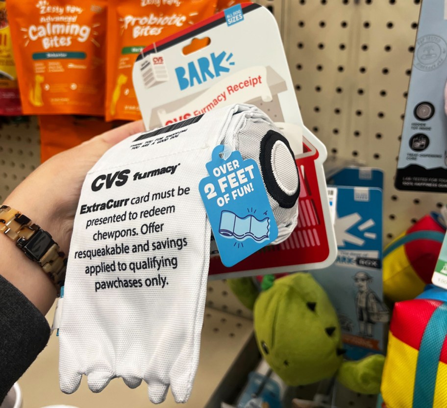 hand holding a dog receipt toy in store