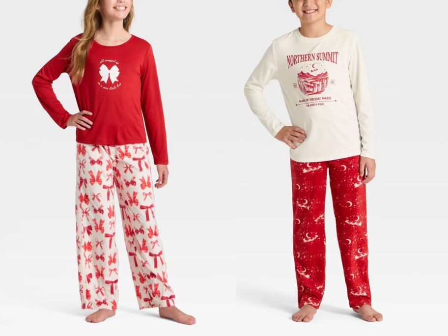 2 kids wearing white and red Christmas pajamas