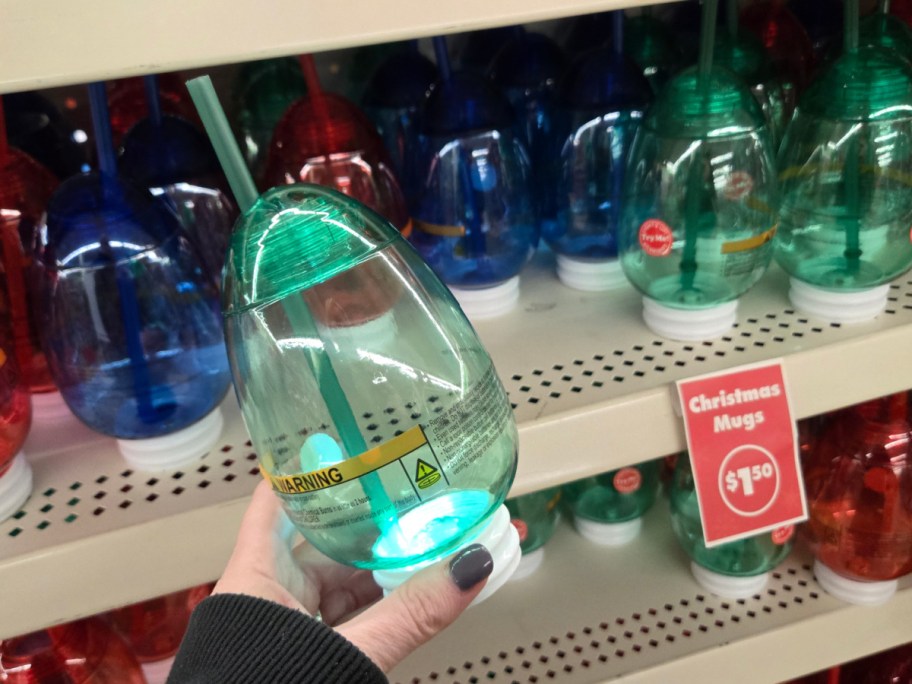 A hand holding up a Christmas light cup at Dollar Tree.