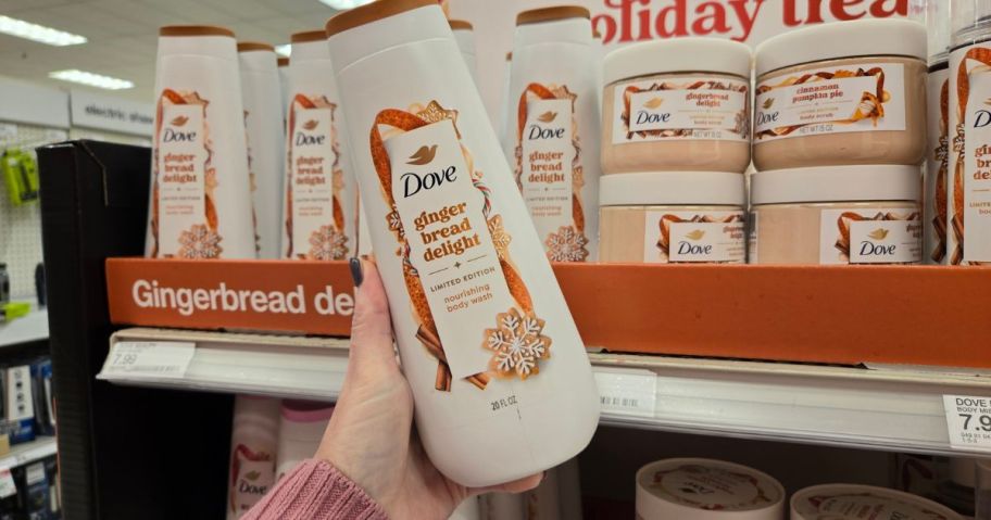 A person holding Dove body wash in a store
