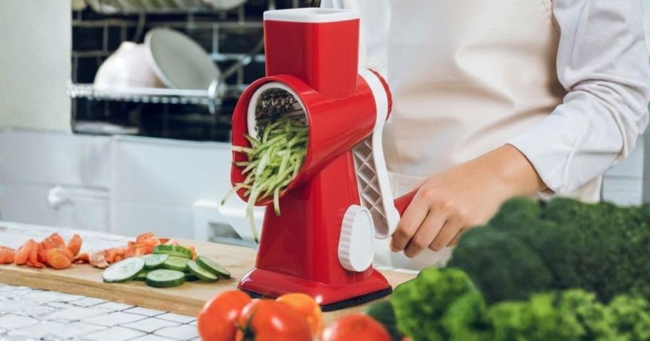 person using Eleko Rotary Cheese Grater in Red