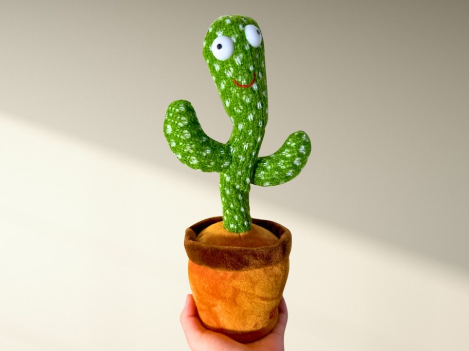 hand holding a Dancing Talking Cactus Toy