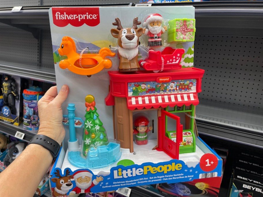 hand holding a Fisher Price Little People Christmas Wonderland Set in the box in a store aisle