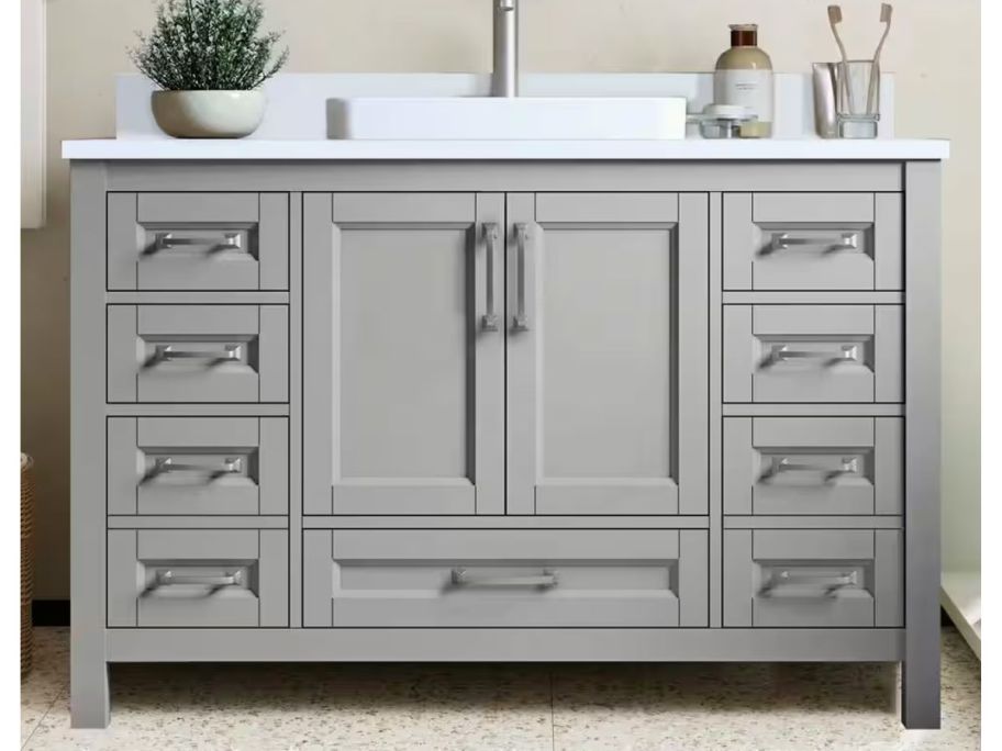 gray bathroom vanity with items on it 