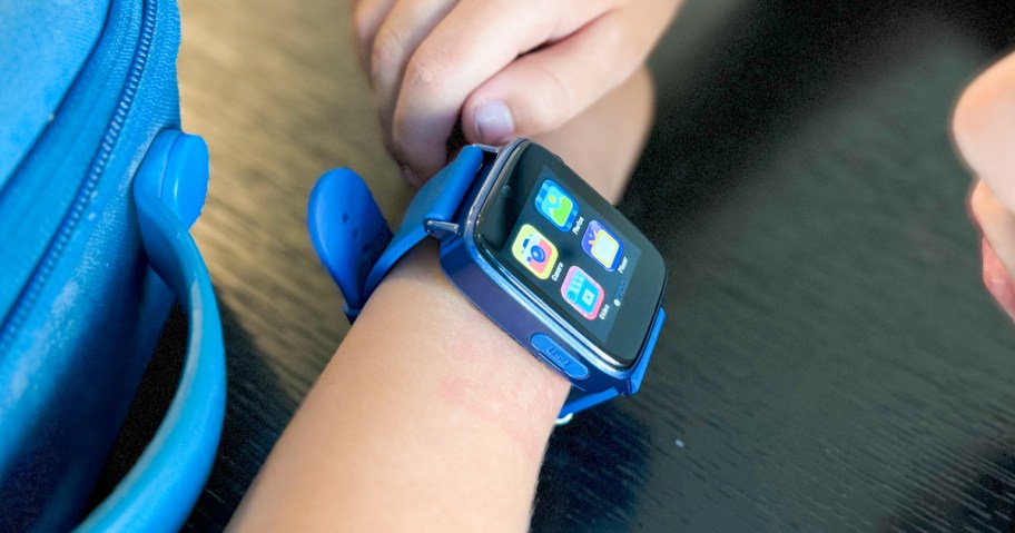 boy wearing a blue and black smartwatch on his wrist