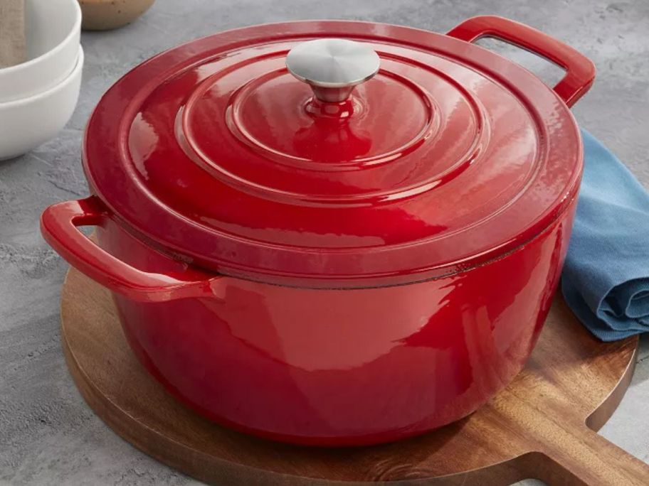 A red Mingle & Co 7qt Enameled Cast Iron Dutch Oven
