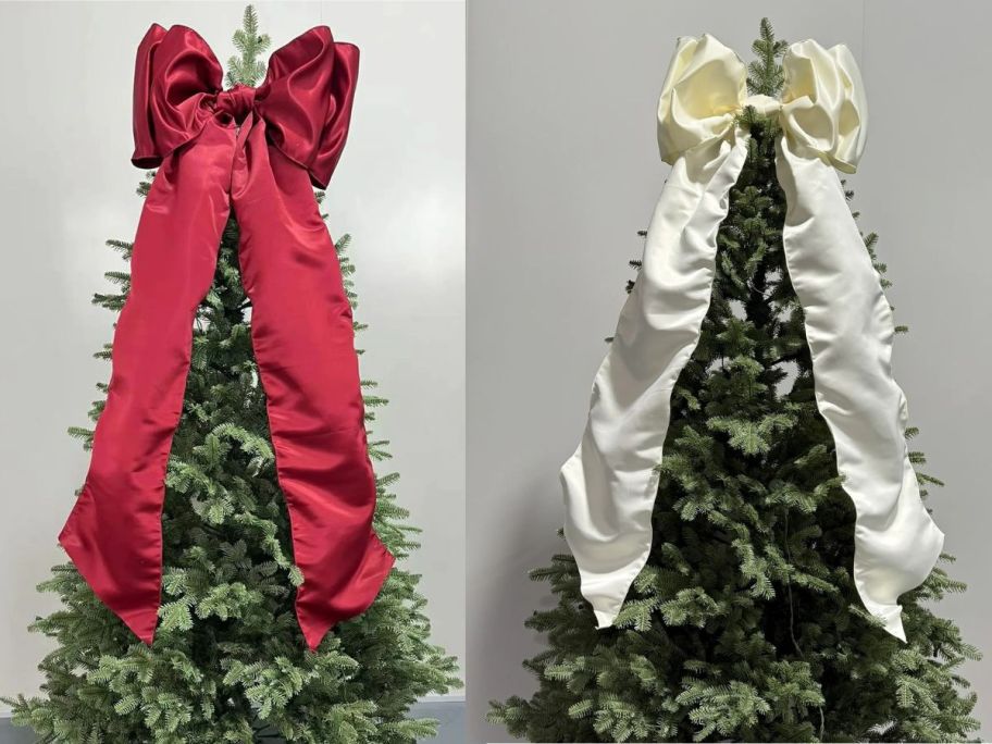 large red and ivory bows at the top of trees