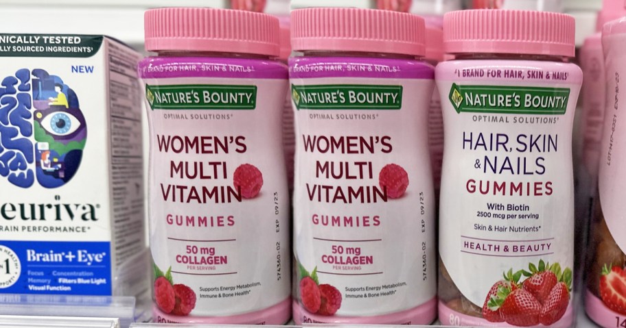 pink bottles of Nature's Bounty Women's Multivitamin Gummies on store shelf