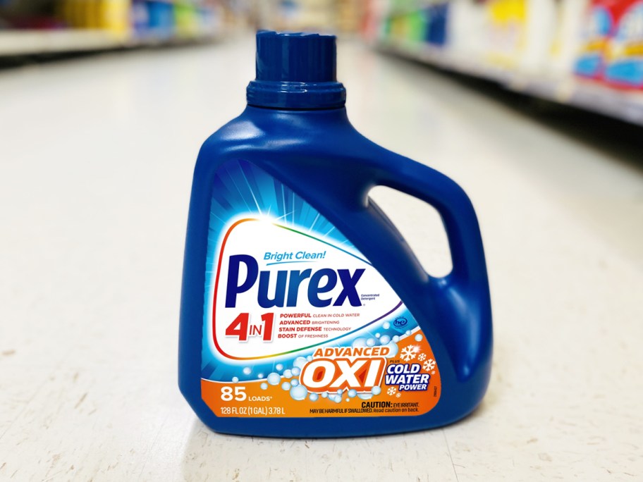 large blue bottle of Purex Liquid Laundry Detergent Plus OXI on floor of store