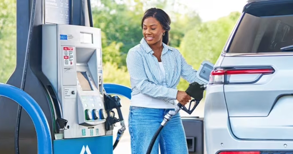 Woman filling up her car with gas at a Sam's Club fuel station