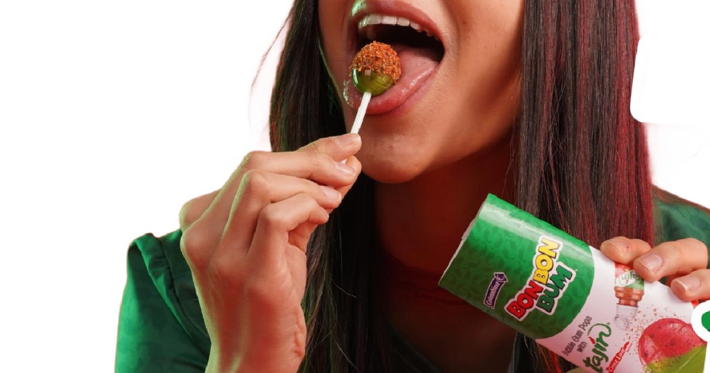 girl licking person holding Bon Bon Bum x Tajín Limited Edition Bubble Gum Lollipop