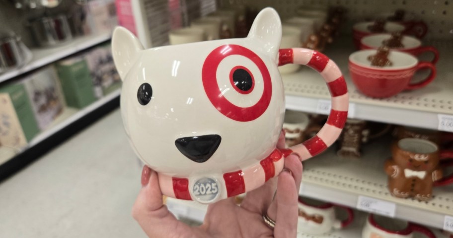 Target Bullseye thmed coffee mug in hand near in-store display