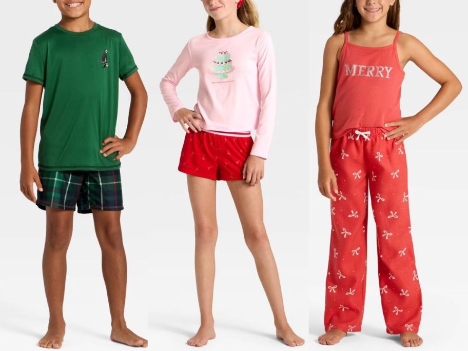 3 kids wearing green, white, and red Christmas pajamas