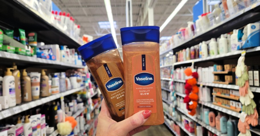 Woman holding up two different bottles of Vaseline gel oils while standing in Walmart store store aisle