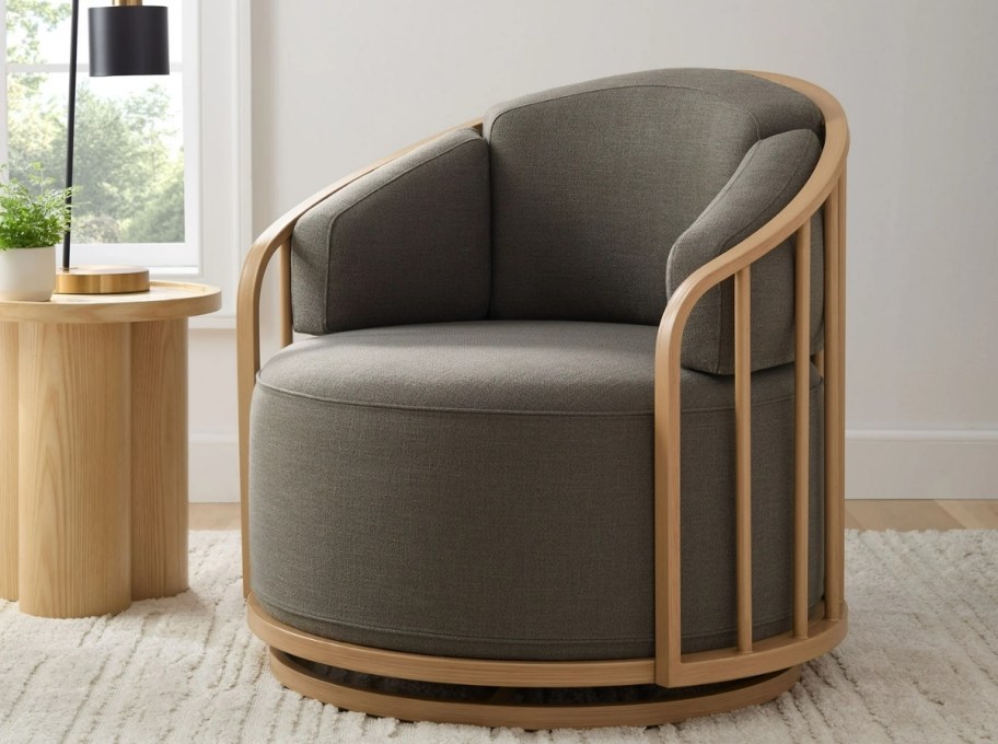 a gray upholstered birdcage swivel chair