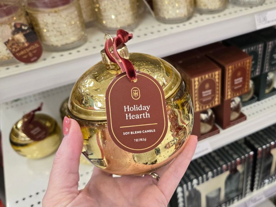 gold Threshold Ornament Figural 7oz Jar Candle in hand in store