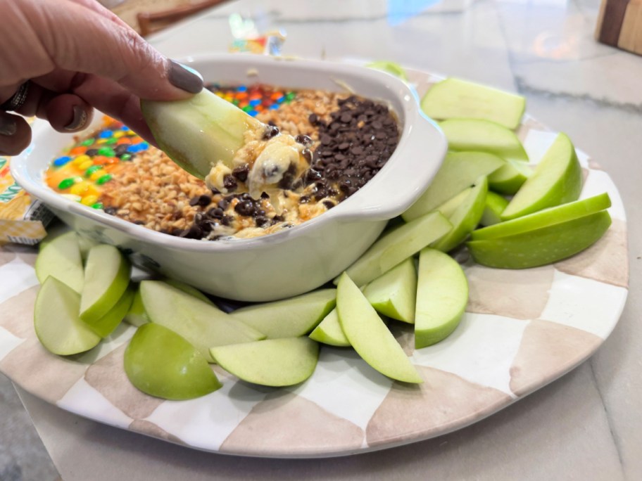 dipping apple in caramel apple dip