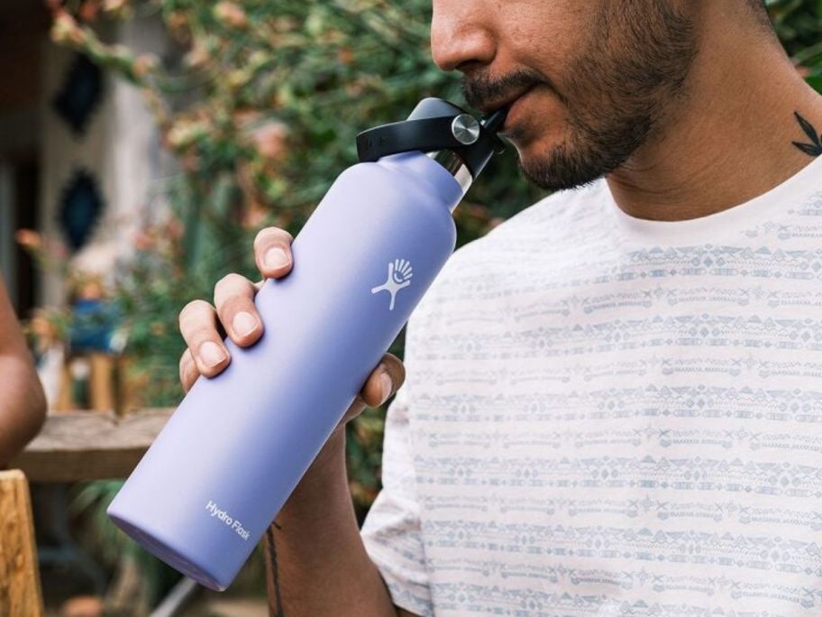 man holding a hydro flask in his hands