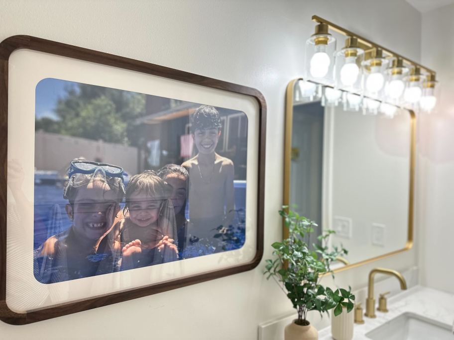 photo of kids in a frame hung on bathroom wall