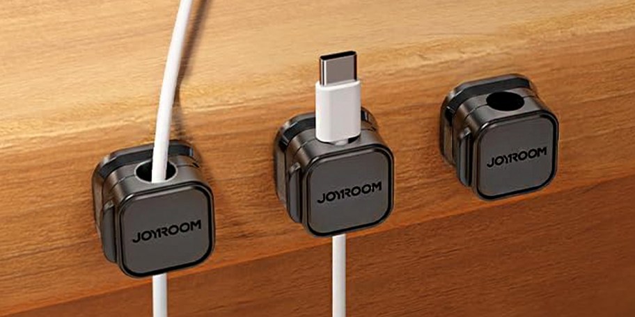 three black cord clips on table