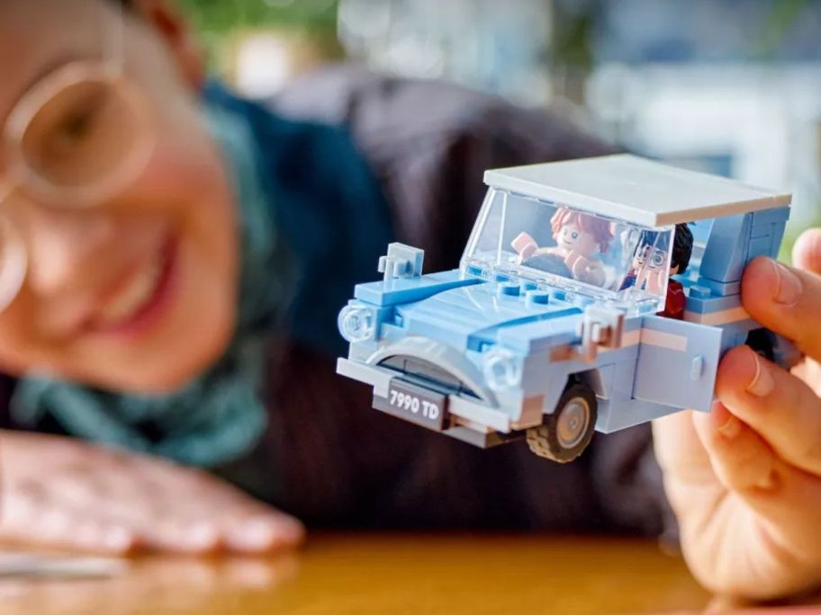 kid playing with LEGO Harry Potter Flying Ford Anglia Car