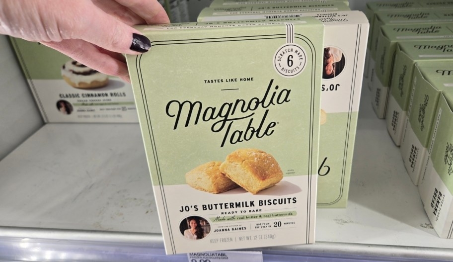 woman hand grabbing a box of frozen buttermilk biscuits from a store freezer