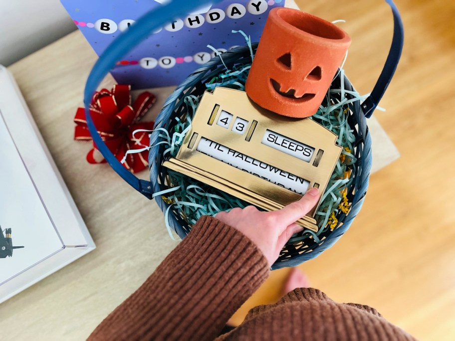 hand turning the perpetual advent calendar showing the halloween option