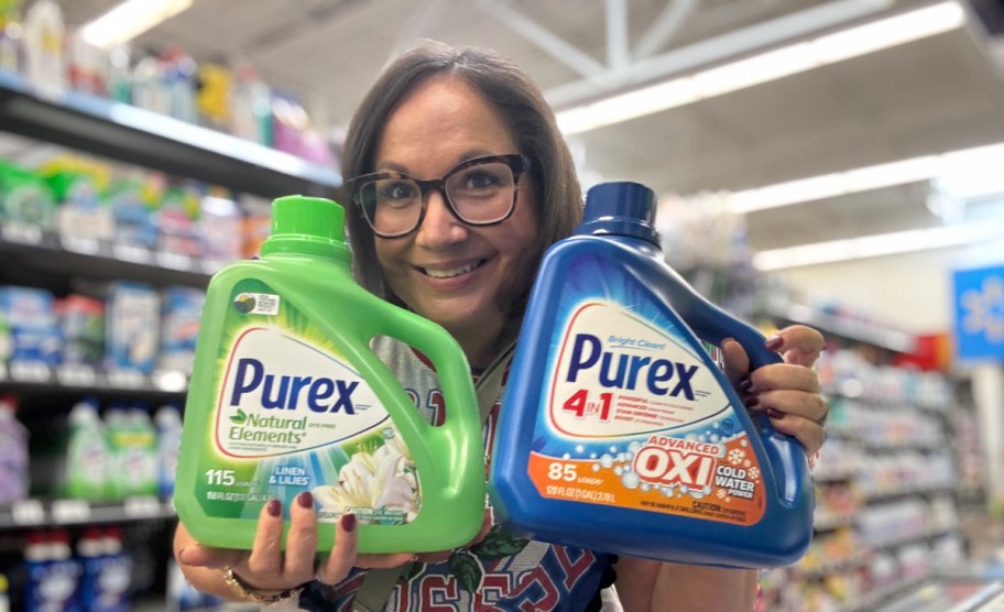smiling woman holding two bottles of purex in a store